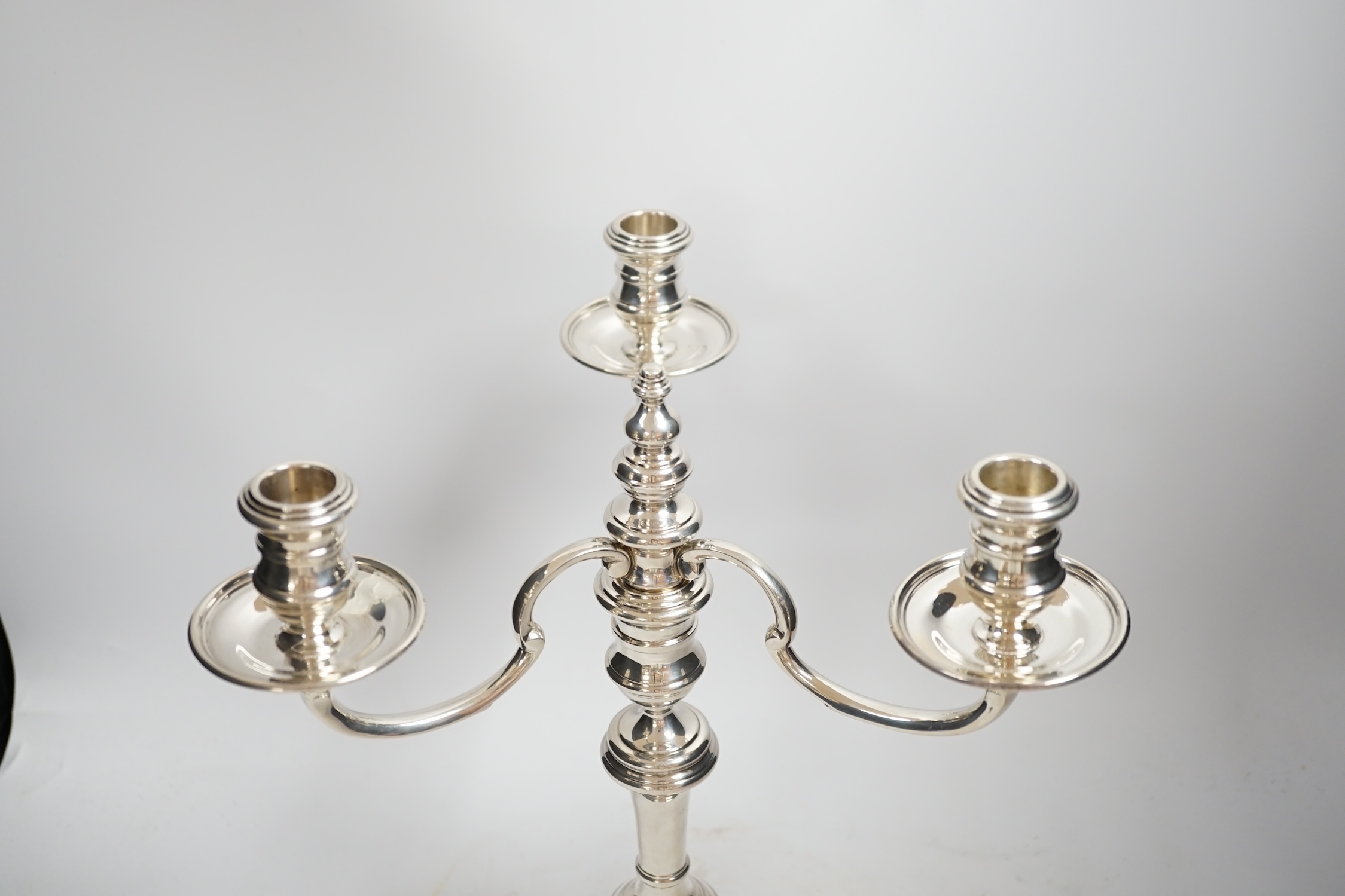An Elizabeth II silver three branch, three light candelabrum, by William Comyns & Sons Ltd, London, 1965, height 34cm, weighable silver 16oz.
